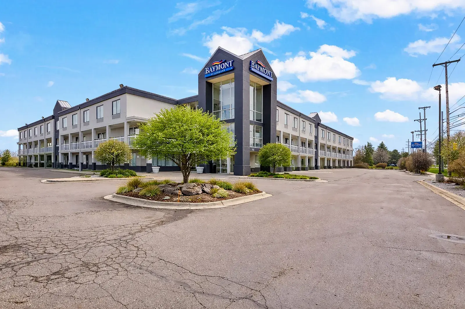Parking lot and exterior view of a Baymont hotel building