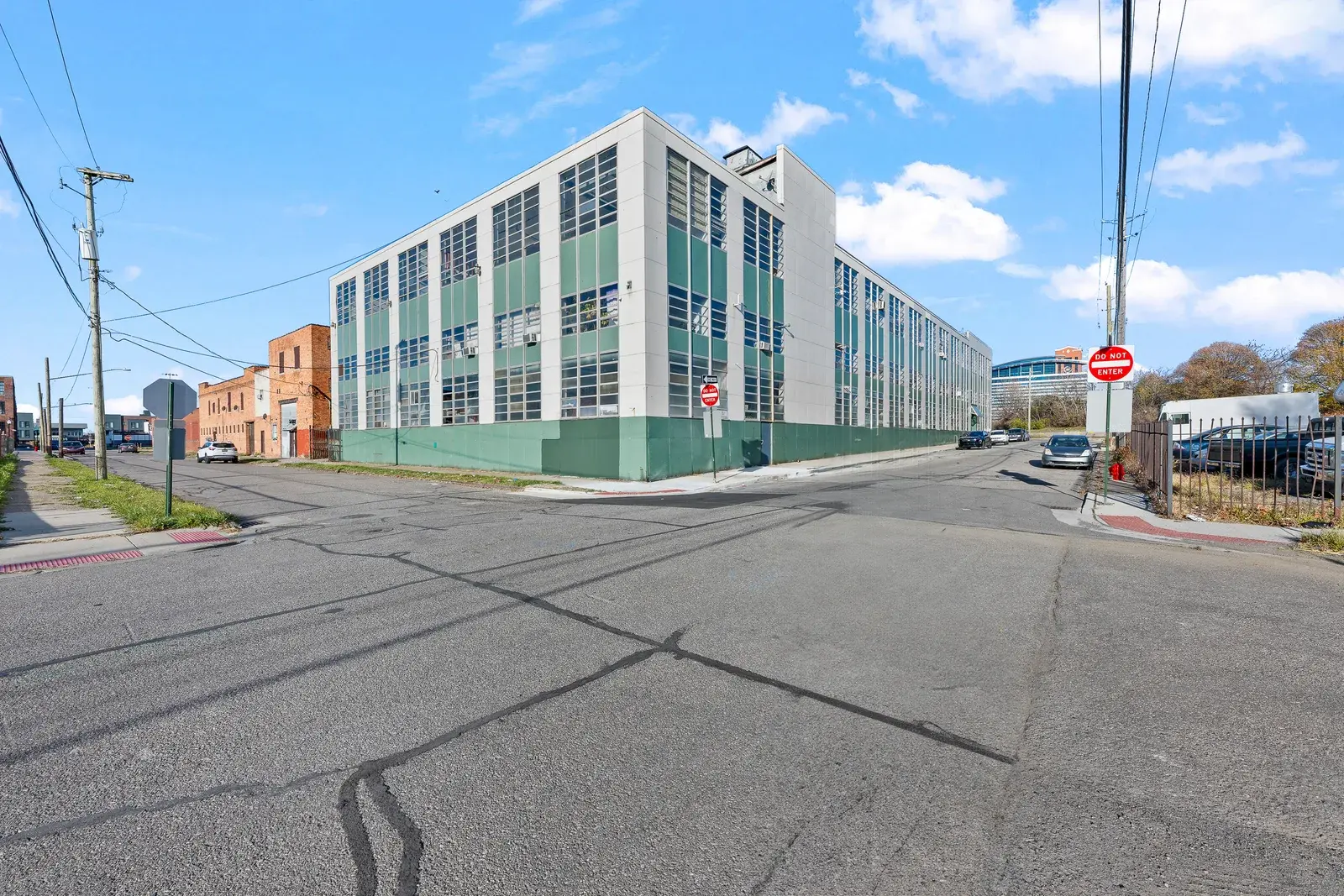 Ground-level view of a parking lot and commercial building