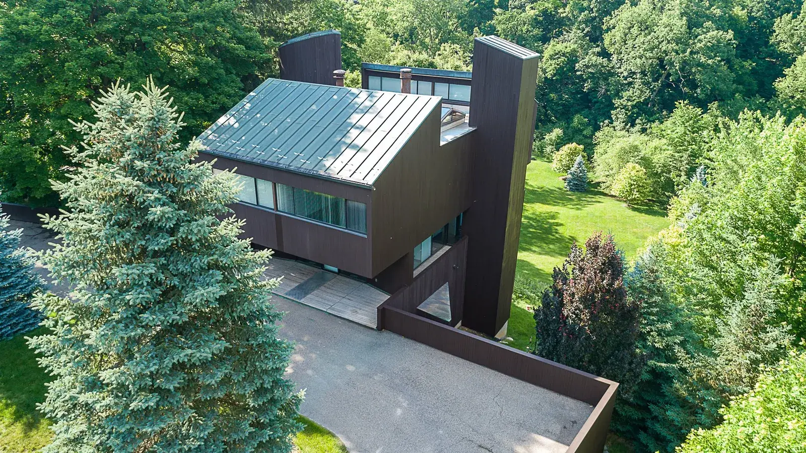 Overhead aerial drone view of a modern cabin home's back door area