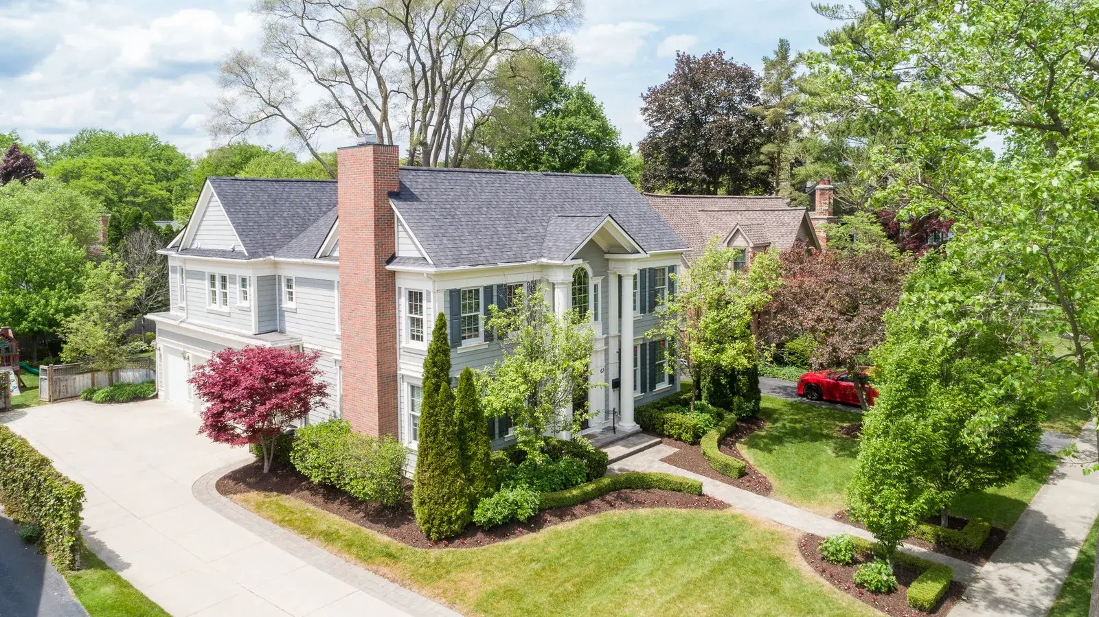 Aerial drone side view of a large mansion-like home