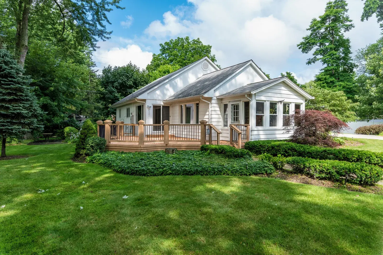 Backyard view of a home with a deck