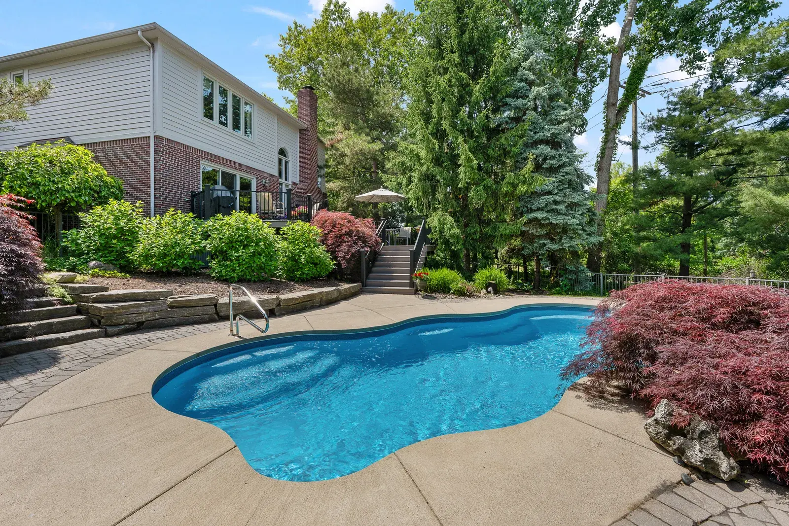 Ground-level backyard view of a home's pool
