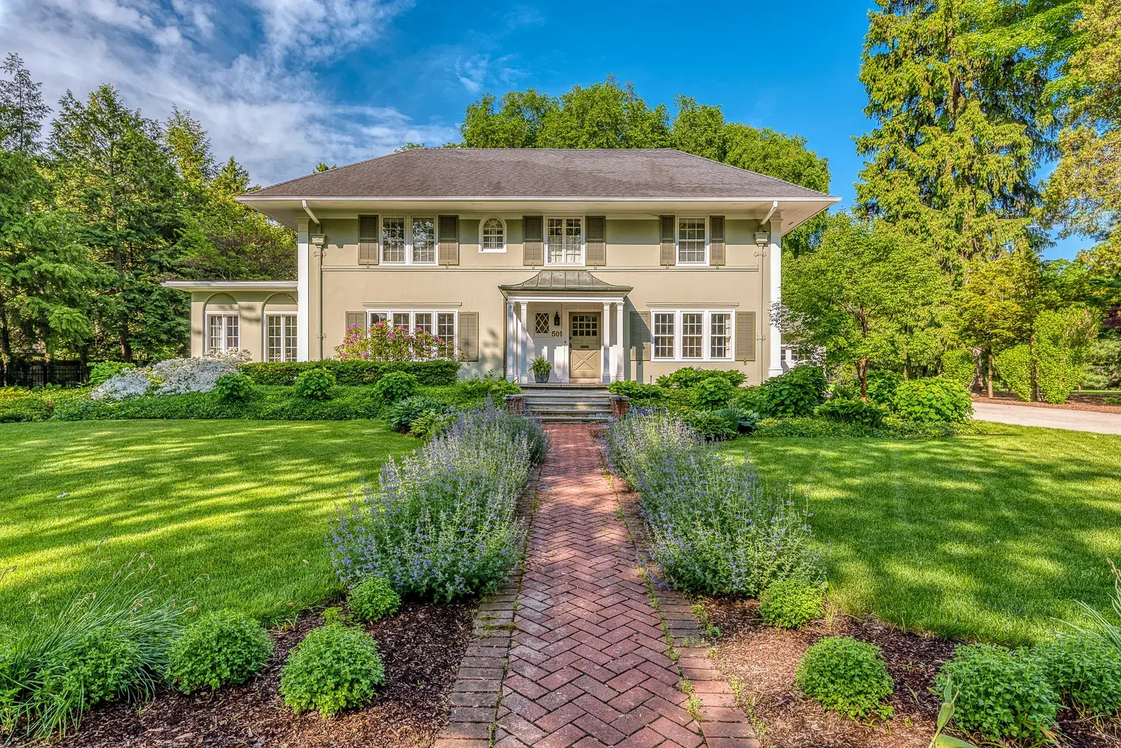 Front lawn of a home with a garden path