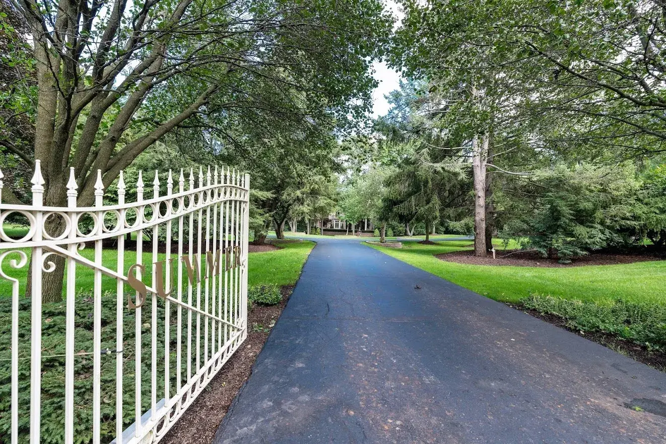 Long driveway leading to a distant home