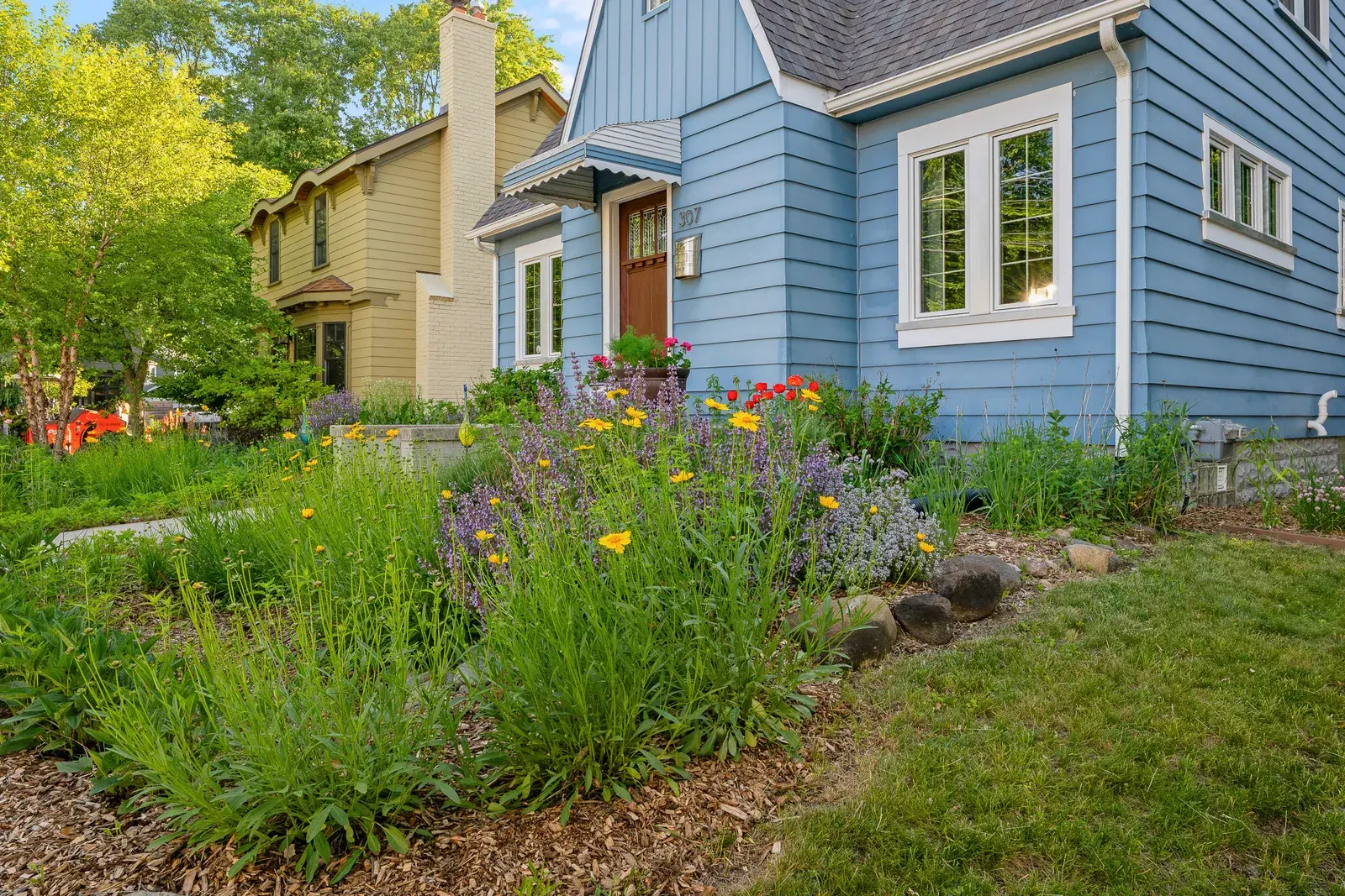 Side lawn view of a home with an overgrown yard