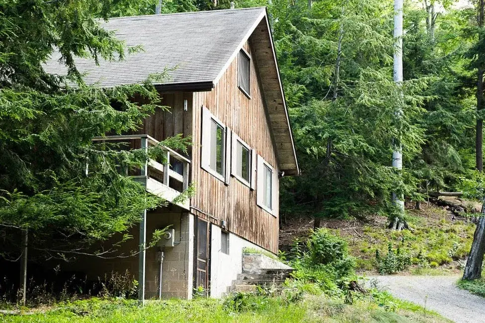 Exterior side view of a wooded cabin-style home