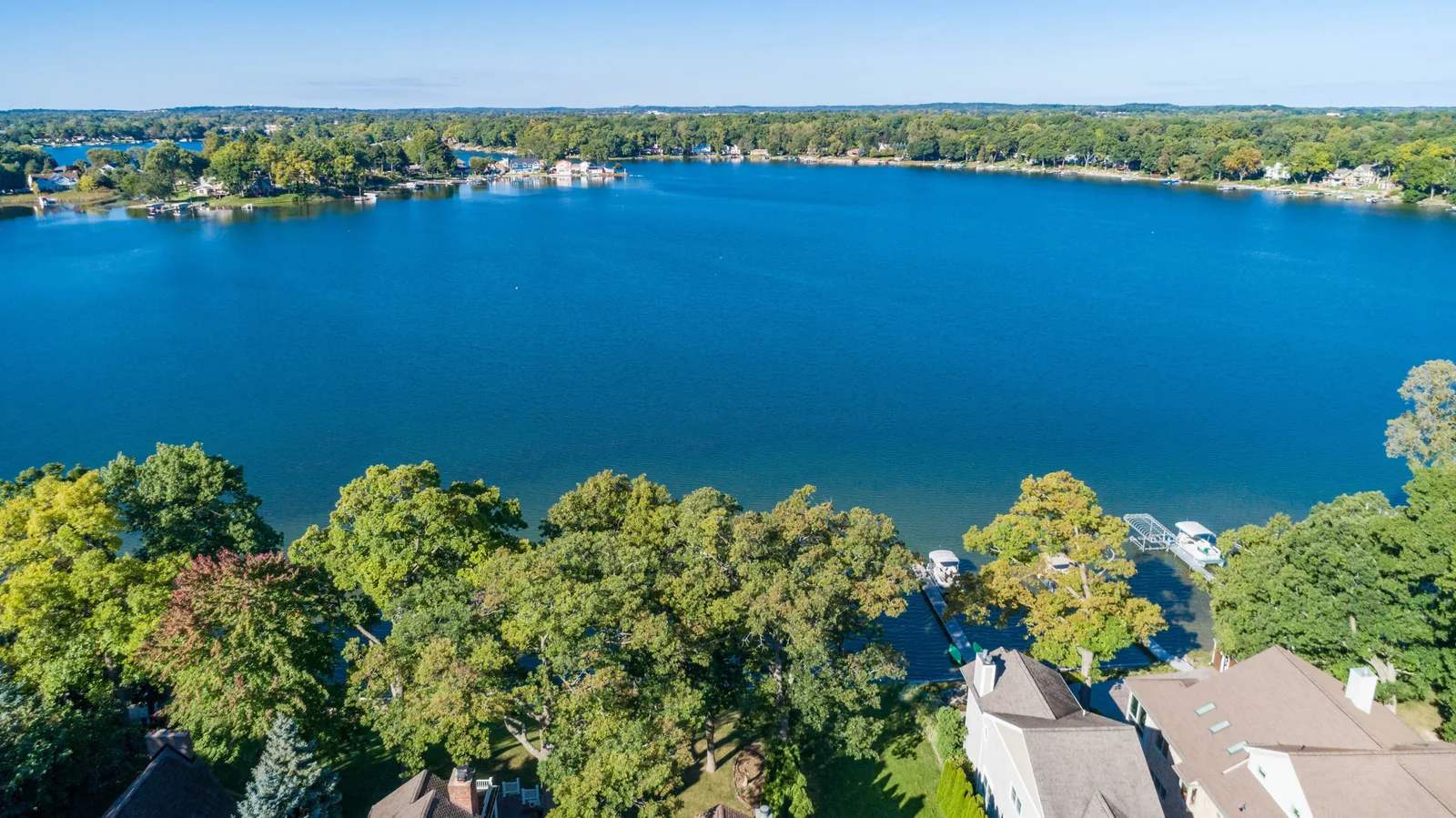 Aerial drone view of a small lake and surrounding properties, common throughout Washtenaw County