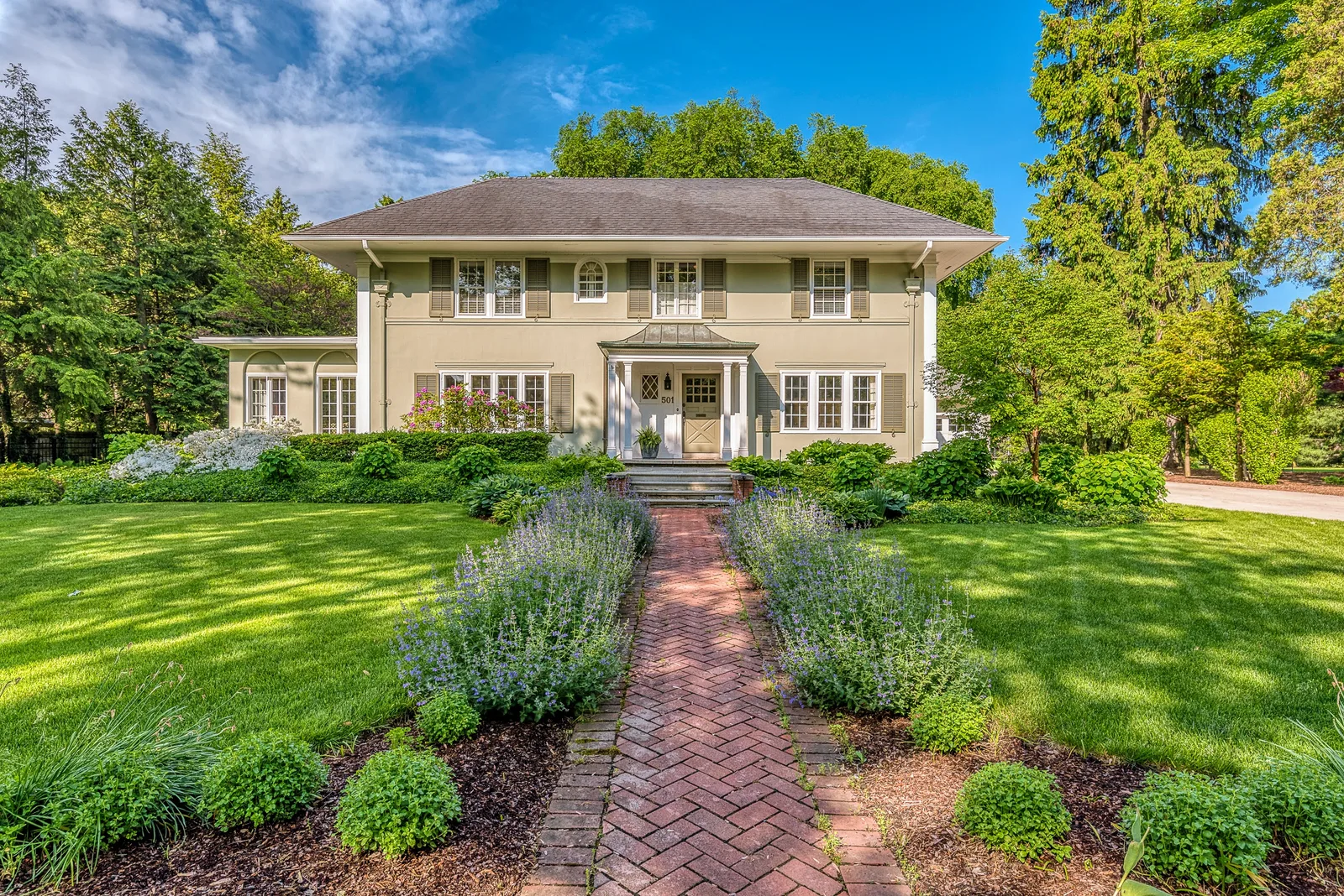 Front lawn of a home with a garden path