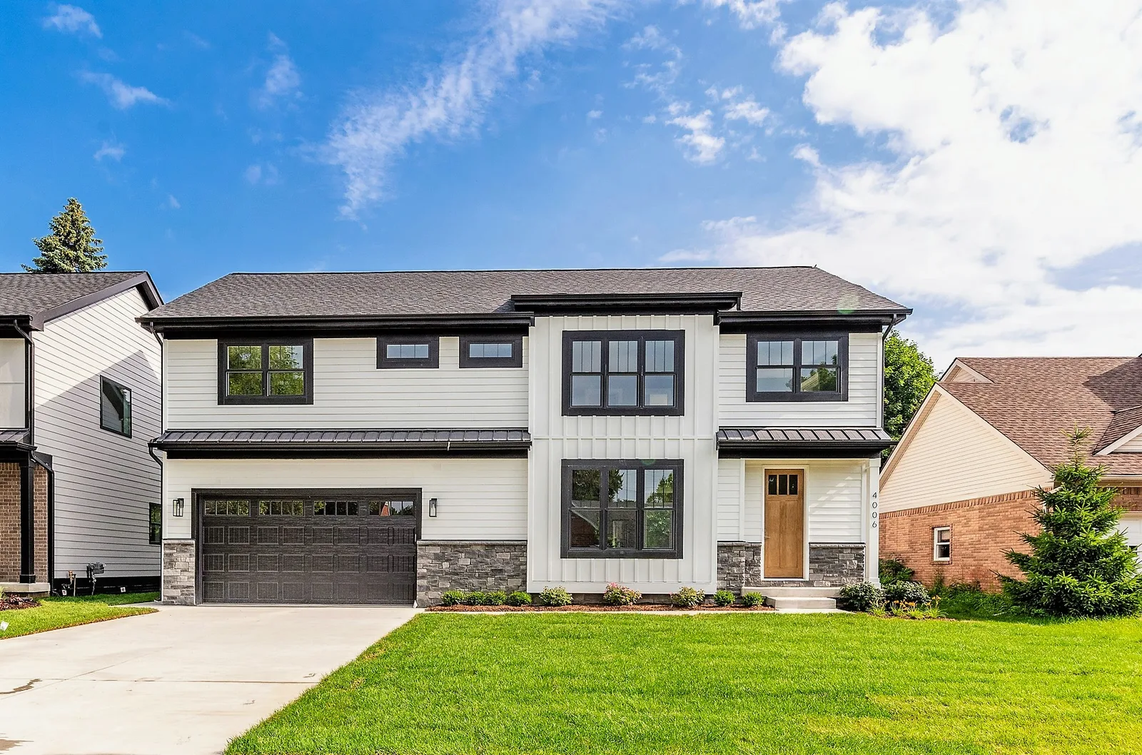 Sunny front lawn view of a modern home, residential real estate photography in Washtenaw County