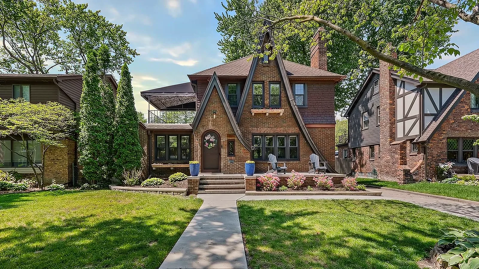 Golden hour sunset view of a brick Tudor-style home's front exterior in Grosse Pointe, Michigan